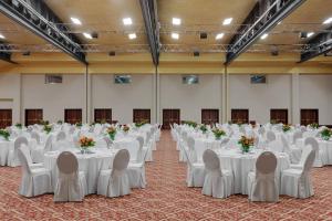 a set up for a banquet in a hall with white tables and chairs at Rome Marriott Park Hotel in Rome