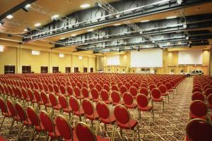 an auditorium with red chairs in a large room at Rome Marriott Park Hotel in Rome