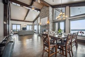 a dining room with a table and chairs at Luxurious Modern 11-Bed Home Private 136 Acres in Spruce Grove