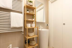 une salle de bain avec un lavabo, des toilettes et un miroir dans l'établissement Sunny retreat near metro, 12 min to Duomo, à Milan
