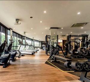a gym with a row of treadmills and machines at Citygate Kamala Condo Paris in Kamala Beach