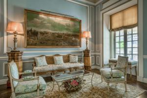 a living room with a couch and a painting on the wall at Santo Mauro, a Luxury Collection Hotel, Madrid in Madrid