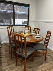 a wooden table and chairs with a table and a window at Sea Lake Holiday Cabin in Sea Lake