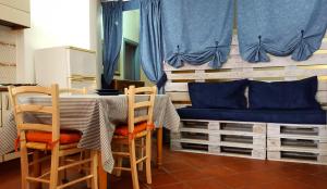 a dining room table with chairs and a blue bench at Casa Gabriella in Fetovaia