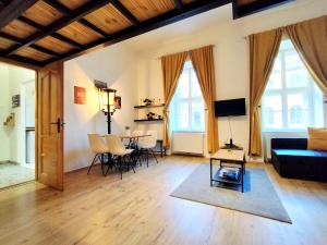 a living room with a couch and a table at MOOKI Rumbach Budapest Apartment in Budapest