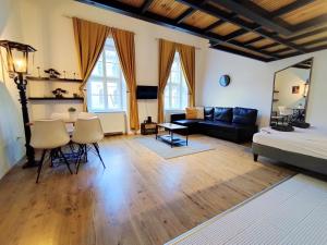 a living room with a couch and a table at MOOKI Rumbach Budapest Apartment in Budapest