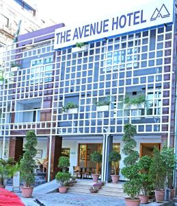 a hotel with a sign that reads the avenue hotel at The Avenue Hotel in Islamabad
