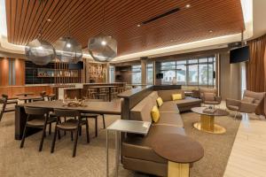 a lobby with a couch and a table and chairs at SpringHill Suites by Marriott Tallahassee North in Tallahassee