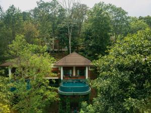 an aerial view of a house in the woods at The Leela Coorg Forest Sanctuary in Madikeri