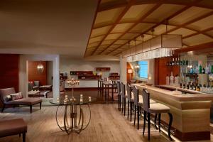 a lobby with a bar and a restaurant at ITC Grand Chola, a Luxury Collection Hotel, Chennai in Chennai