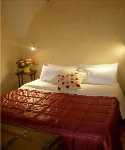 a bedroom with a bed with white sheets and pillows at Villa Mont des Oliviers CITRA-8055LT-1805 e 1807 in Sanremo