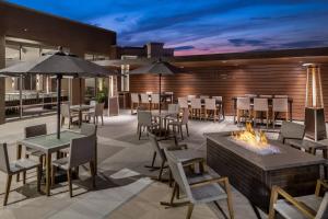 a patio with a fire pit and tables and chairs at San Diego Marriott Del Mar in San Diego