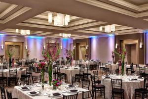 a banquet hall with tables and chairs with flowers at San Diego Marriott Del Mar in San Diego +58 photos
