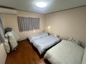 Postel nebo postele na pokoji v ubytování こころハウス