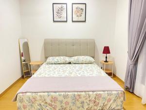 a bed in a bedroom with two pillows on it at NVilla Splashmania Gamuda Cove - Mayabay Residences in Banting +36 photos