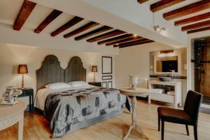 a bedroom with a bed and a desk and a chair at Maison Saunières in Saunières +25 photos
