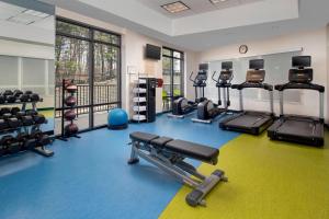 a gym with several treadmills and machines in a room at SpringHill Suites Potomac Mills Woodbridge in Woodbridge