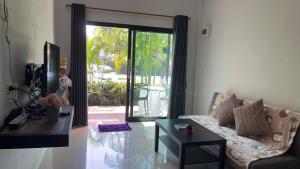 a living room with a couch and a table at The White House Ao Nang in Ao Nang 