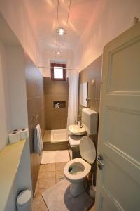a small bathroom with a toilet and a sink at Guesthouse Sermageova in Zagreb