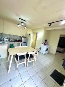 a kitchen with a table and chairs in a room at Kanso Hill Guesthouse in Ranau