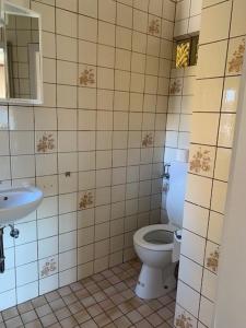 a bathroom with a toilet and a sink at Monteurpension Haus Monika in Marktheidenfeld +9 photos
