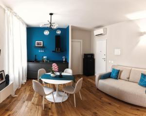 a living room with a table and a couch at Boccaccio Apartment in Ravenna