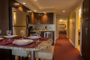 a kitchen with a table with plates and wine glasses at Golden Gables Inn in North Conway