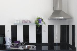 A cozinha ou kitchenette de Alojamento Local S. Bartolomeu