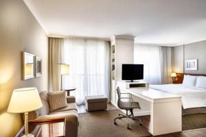 a hotel room with a bed and a desk at Marriott Executive Apartments Sao Paulo in Sao Paulo +29 photos