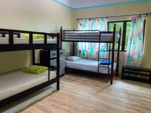 a room with three bunk beds and a window at Mountain Lodge, Radiant Janda Baik in Bentong