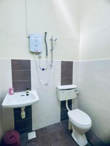 a bathroom with a toilet and a sink at Rosali Homestay in Malacca +25 photos