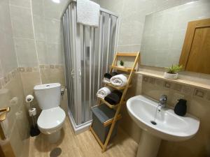 a bathroom with a toilet and a sink and a shower at Casa fina y pepe in Algar