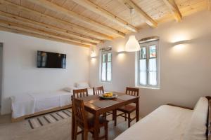 a room with a dining table and a bedroom at K Homes-Family Stone Suite in Tinos Town