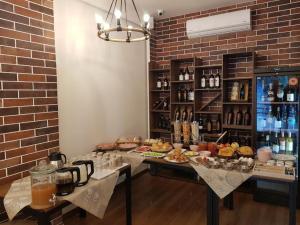 a room with a table with food and drinks at Crown Boutique Hotel in Durrës +54 photos