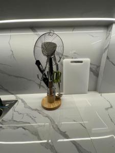 a small fan sitting on a counter in a kitchen at Monde Residence Block K number 17 in Bagam +27 photos