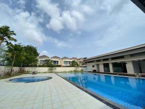 a swimming pool in front of a building at Monde Residence Block K number 17 in Bagam
