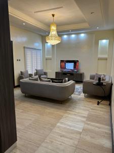 a living room with a couch and a television at Urban Oasis Kaduna in Kaduna