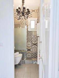 a bathroom with a toilet and a chandelier at Nafplio Private Studio 2 in Nafplio +40 photos