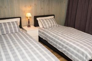 two beds sitting next to each other in a bedroom at Amberfish in Tromsø