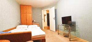 a bedroom with a bed and a television in it at 1к квартира на Подолі В будинку є укриття in Kyiv