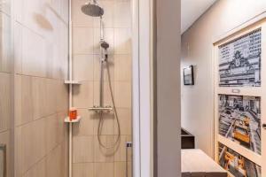 a bathroom with a shower with a shower head at Chatillon in Châtillon +11 photos