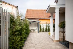 a courtyard of a house with a fence and a patio at Olivia 9teen Hotel Boutique in Sibiu