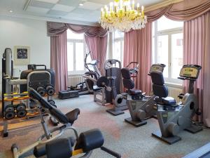 a gym with many exercise equipment in a room at Golf Hotel Des Alpes in Samedan +46 photos