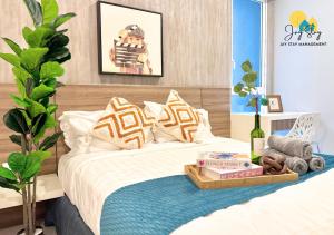 a bedroom with a bed with a tray on it at The Shore l Exclusive Private Garden l Luxury Suite l 4-9 pax l Melaka River View l Direct Mall l Jonker Street by Jay Stay Management in Melaka +160 photos