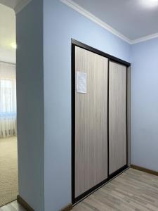 a room with a door with a sign on it at Shygys_hotel in Aktau