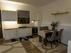 a kitchen and dining room with a table and chairs at PS Apartment Polydrosos - PS Rental in Polydrossos
