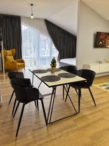 a living room with a table and chairs at Cottage Gutsulia in Yaremche