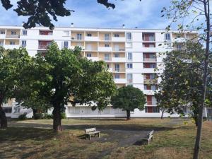a white building with two benches in a park at BonaBonheur - T3Bis - Havre de Paix Toulousain in Toulouse