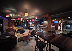 a restaurant with a table and chairs and a bar at Fontaine du Mont Blanc Hotel & Spa in Les Houches