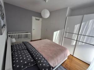 a small bedroom with a bed and a window at Apartman Tonka in Šibenik